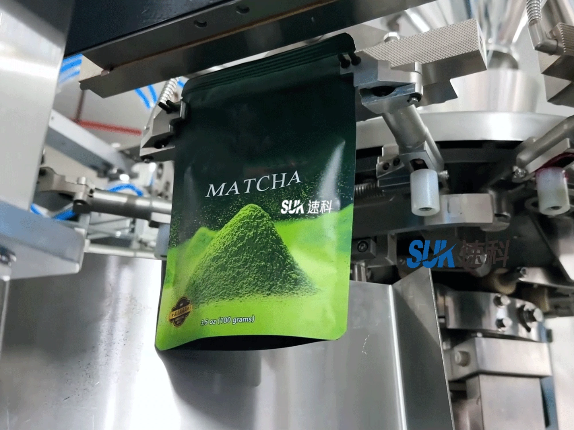 Matcha powder pouch at the sealing and coding station of a pouch packing machine