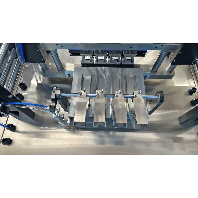SUK salt sachet machine discharge and chute mechanism detail - real SUK equipment photo