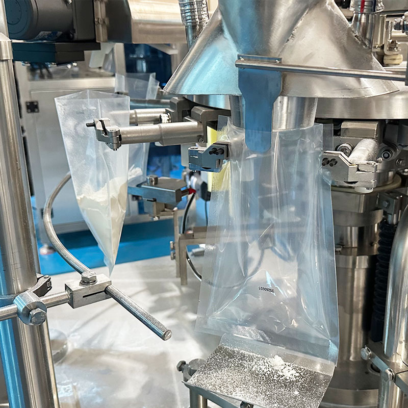 Doypack gripper holding an open coffee bag on a SUK premade pouch packaging machine